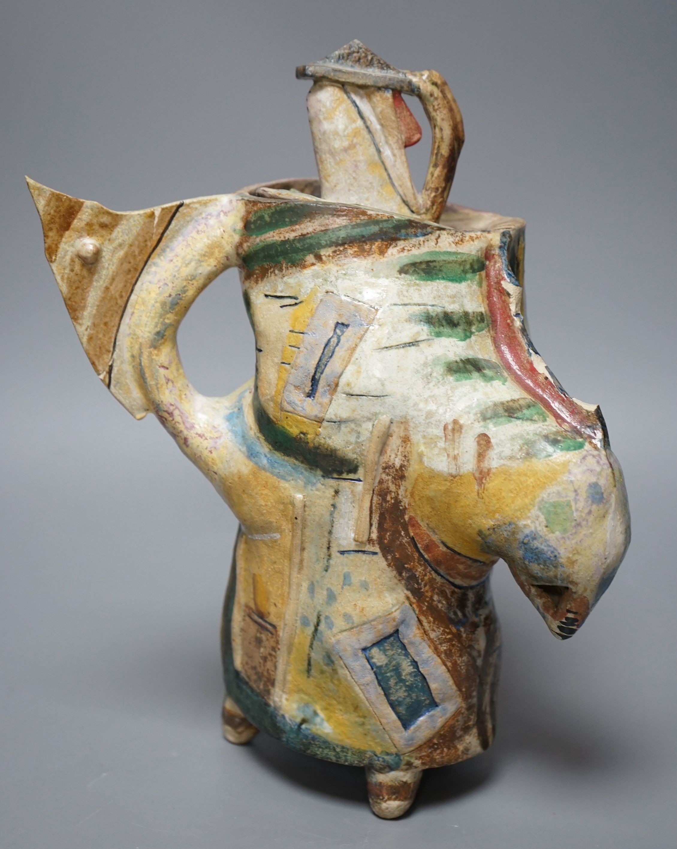 Angus Suttie (1946-1993), an abstract polychrome glazed stoneware jug and cover on tripod base, inscribed ‘Angus 86’, 29cm tall (Damage)